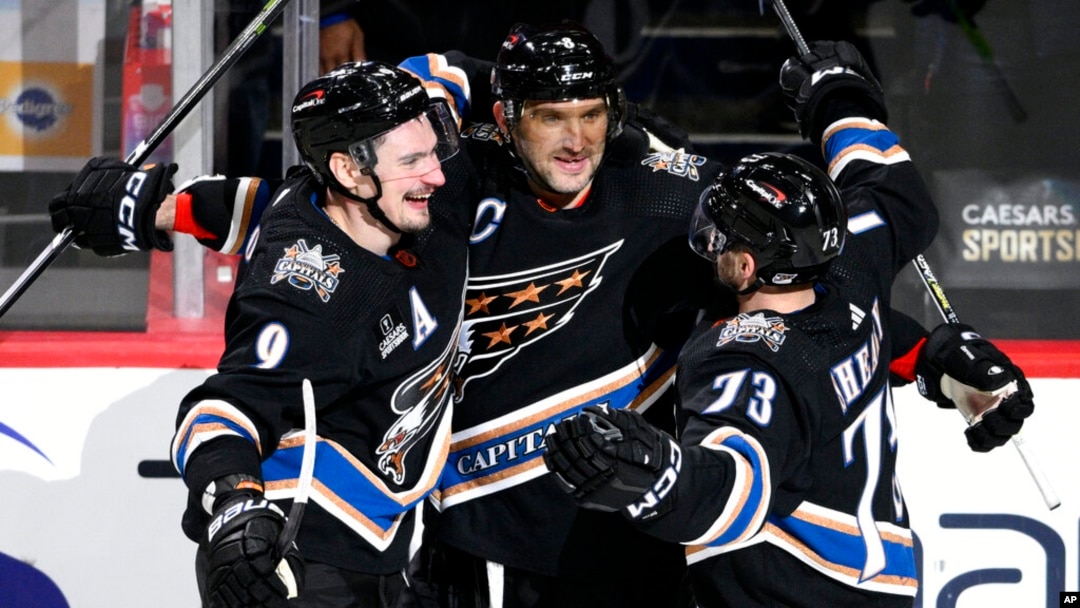 Washington Capitals left wing Alex Ovechkin (8) celebrates his goal with defenseman Dmitry Orlov (9) and left wing Conor Sheary (73) during the third period of an NHL hockey game against the Winnipeg Jets, Dec. 23, 2022, in Washington.