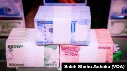 FILE: Illustration of bundles of new Nigerian naira currency notes. Taken Nov. 23, 2022
