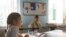 Daria Kosova attends a mathematic lesson at a private school, amid Russia's attack on Ukraine, in Kyiv, Ukraine, Dec. 1, 2022. 