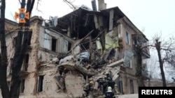 Rescuers work at the site of a residential building damaged by a Russian missile amid their attack on Ukraine, in Kryvyi Rih, Ukraine December 16, 2022. 