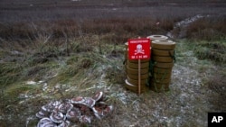 FILE - Anti-tank mines are seen in the field near the recently liberated village of Pravdyne, Kherson region, Ukraine, Dec. 6, 2022.