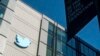 FILE - A Twitter logo hangs outside the company's San Francisco offices on Nov. 1, 2022. 