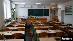 Teacher Tetiana Olifirova conducts an online chemistry lesson in a classroom at a school amid Russia's attack on Ukraine, in Kyiv, Ukraine, Dec. 2, 2022.