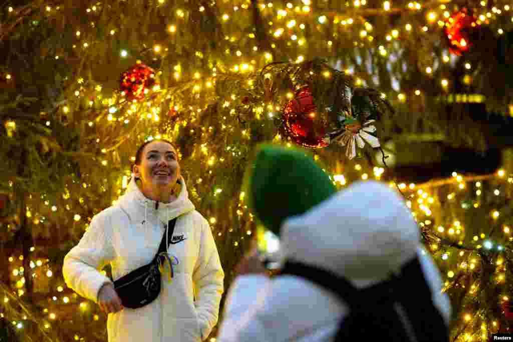 Una mujer posa para una foto en un mercado navideño de Riga, Letonia, el 2 de diciembre de 2022.