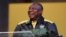 South Africa's President Cyril Ramaphosa laughs as he addresses Africa natinal Congress (ANC) delegates at the National Recreation Center (Nasrec) in Johannesburg on July 29, 2022. 