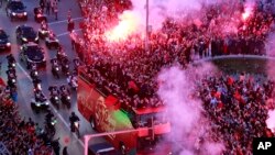 FILE - Fans celebrate during a homecoming parade of Morocco national soccer team in central Rabat, Morocco, Tuesday, Dec. 20, 2022.