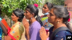 FILE - Visa seekers gather to pray at the Sri Lakshmi Visa Ganapathy Temple in Chennai, India on Nov. 28, 2022.