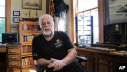 FILE - Paul Watson, founder of the Sea Shepherd Conservation Society, made famous by the television show "Whale Wars" discusses a recent legal battle over anti-whaling activities, at his home office in Woodstock, Vermont, Aug. 23, 2016. 
