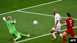 Denmark's goalkeeper Kasper Schmeichel spreads himself to save a shot from Tunisia's forward Issam Jebali during the World Cup Group D match between Denmark and Tunisia at the Education City Stadium in Al-Rayyan, Qatar on November 22, 2022.