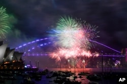 Des feux d'artifice explosent au-dessus du pont du port de Sydney lors d'un premier feu d'artifice avant les célébrations du Nouvel An à Sydney, le 31 décembre 2022.