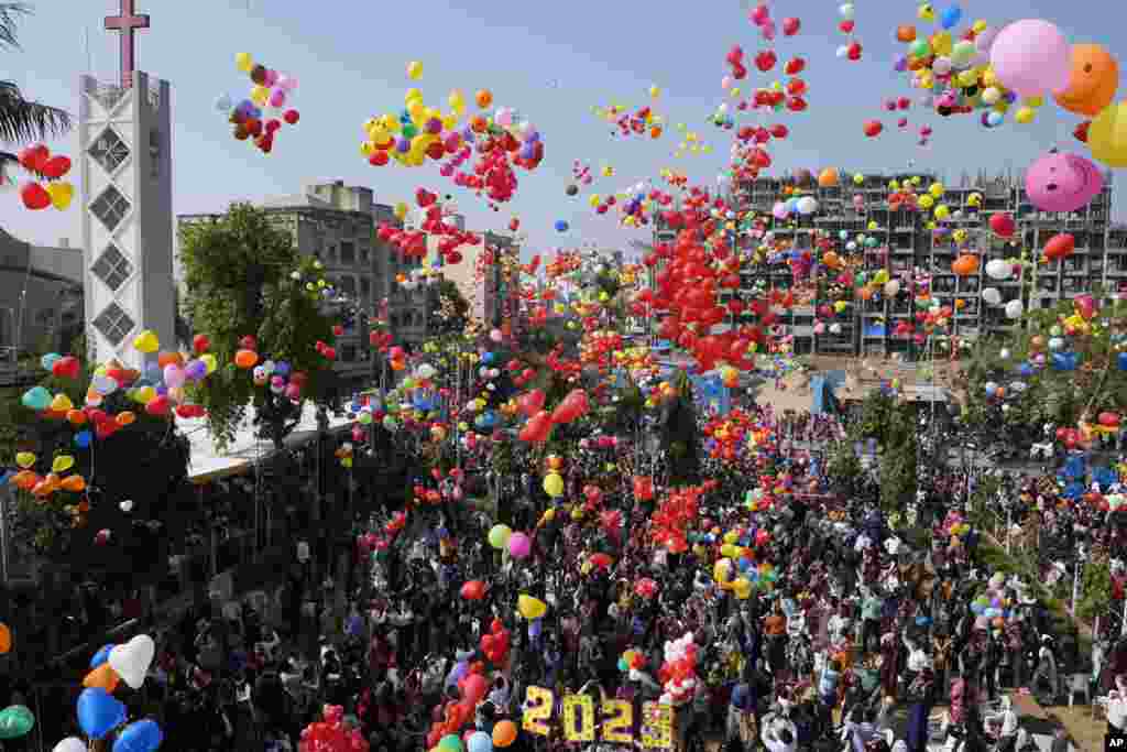 Indian Christians release balloons to celebrate the New Year after offering prayers at a Church in Ahmedabad, Jan. 1, 2023.