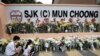 Students place flowers at the entrance of the SJK (C) Mun Choong school in Kuala Lumpur, Malaysia, Sunday, Dec. 18, 2022. Seven female teachers from the school were on an unofficial camping trip at an organic farm that was hit by a landslide, Friday, Dec. 16, 2022.