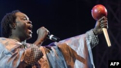 FILE: Senegalese singer Baaba Maal performs on stage on December 11, 2015 at the Obelisque square in Dakar, during a concert for the Planet held on the last day of COP21. 