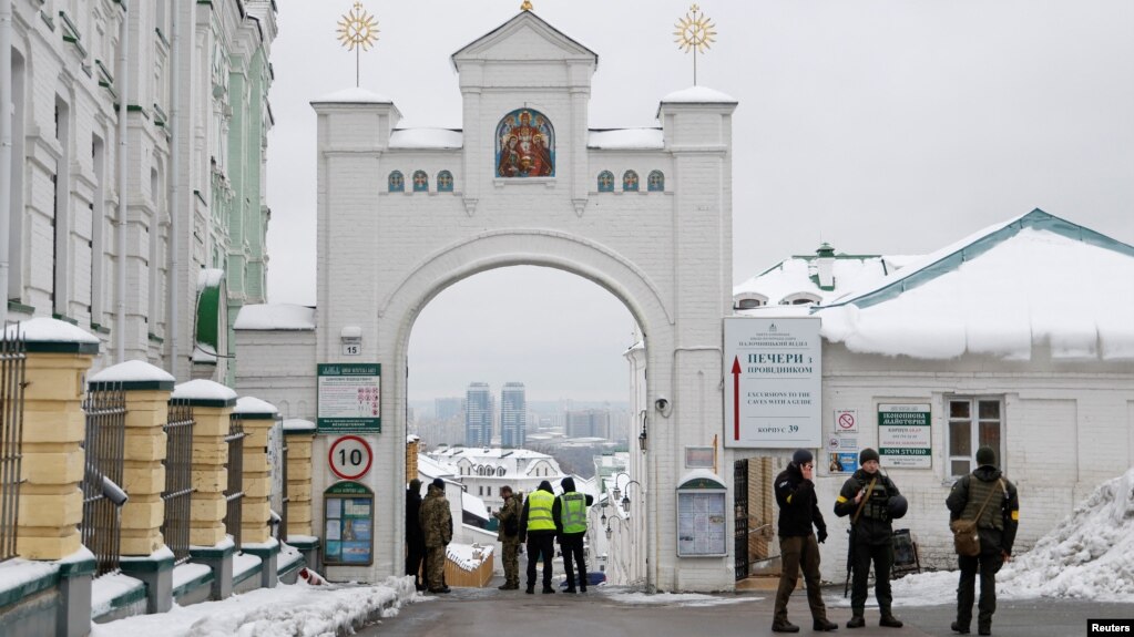 Ukrainian law enforcement officers stand next to an entrance to the Kyiv Pechersk Lavra monastery compound, amid Russia's attack on Ukraine, in Kyiv, Nov. 22, 2022. 