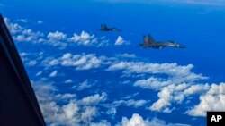 FILE - In this photo released by Xinhua News Agency, fighter jets of the Chinese People's Liberation Army (PLA) conduct a joint combat training exercises around Taiwan on Aug. 7, 2022.