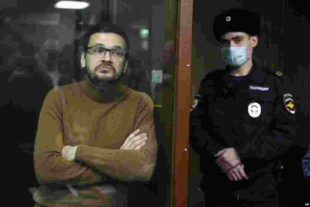 Russian opposition activist and former municipal deputy of the Krasnoselsky district Ilya Yashin stands in a cage in a courtroom prior to a hearing in Moscow, Russia.