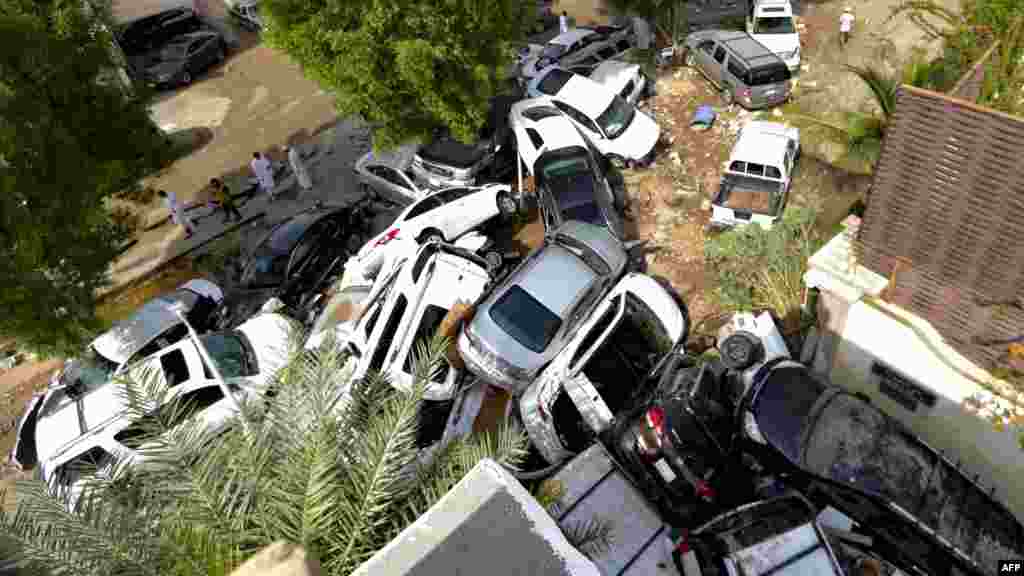 Cars that were washed away by heavy rains are piled up in an alley in the coastal city of Jeddah, Saudi Arabia.
