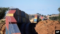 FILE - A long row of double-stacked shipping containers provides a wall between the United States and Mexico in a remote section of San Rafael Valley, Ariz., Dec. 8, 2022.