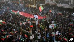 FILE - Supporters of Pakistan's former Prime Minister Imran Khan's 'Pakistan Tehreek-e-Insaf' party attend a rally, in Rawalpindi, Pakistan, Nov. 26, 2022.