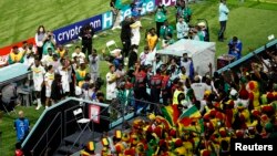 Senegal's players celebrate with fans after qualifying for the knockout stages of the World Cup with a victory over Ecuadoar on Nov. 29, 2022, at Khalifa International Stadium in Doha, Qatar. 