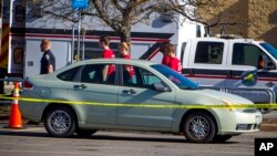 A vehicle belonging to shooter Andre Bing is blocked off with police crime scene tape in the parking lot of a Walmart Supercenter, Nov. 23, 2022, in Chesapeake, Va.