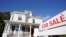 FILE: FILE - A for sale sign stands in front of a house on Oct. 6, 2020, in Westwood, Mass.
