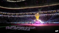 The World Cup Trophy is illuminated prior the World Cup, group A soccer match between Qatar and Ecuador at the Al Bayt Stadium in Al Khor, Nov. 20, 2022.
