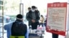 People register to collect free medicine donated by merchants and residents at a public service center in Tonglu, in China's eastern Zhejiang province on Dec. 23, 2022.