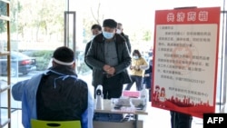 People register to collect free medicine donated by merchants and residents at a public service center in Tonglu, in China's eastern Zhejiang province on Dec. 23, 2022.