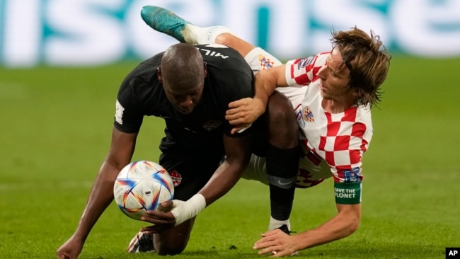 Croatia's Luka Modric fights for the ball with Canada's Kamal Miller during the World Cup group F soccer match between Croatia and Canada, at the Khalifa International Stadium in Doha, Qatar, Nov. 27, 2022.