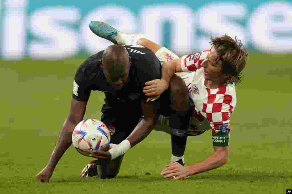 Croatia&#39;s Luka Modric fights for the ball with Canada&#39;s Kamal Miller during the World Cup group F soccer match between Croatia and Canada, at the Khalifa International Stadium in Doha, Qatar.