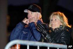 President Joe Biden whistles at the end of a performance as first lady Jill Biden applauds during the annual Christmas Tree Lighting ceremony in Nantucket, Mass., Friday, Nov. 25, 2022.