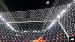England's Harry Kane blasts a penalty over the bar to miss as France's goalkeeper Hugo Lloris dives during the World Cup quarterfinal soccer match between England and France, at the Al Bayt Stadium in Al Khor, Qatar, Dec. 10, 2022.