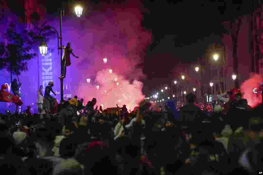 Moroccans gather to celebrate Morocco's win over Spain in a World Cup match played in Qatar, in Rabat, Dec. 6, 2022.