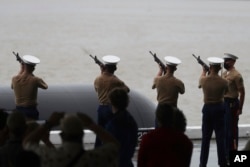 FILE - The U.S. Marine Corp. fires a rifle salute at the 80th Pearl Harbor Anniversary ceremony at Joint Base Pearl Harbor-Hickam, in Honolulu, Dec. 7, 2021.