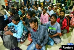 Rohingya refugees wait at a temporary shelter in Pidie, Aceh province, Indonesia, December 26, 2022.