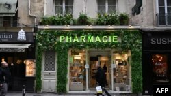 A man walks past a pharmacy in Paris, France, Nov. 24, 2022.