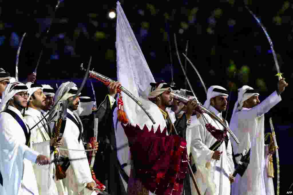 Dancers wave flags of the World Cup teams as they perform during the opening ceremony ahead of the Qatar 2022 World Cup Group A football match between Qatar and Ecuador.&nbsp;