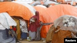 FILE - A Somali woman stands in the Alla Futo camp for internally displaced people, on the outskirts of Mogadishu, Somalia, Sept. 23, 2022. 