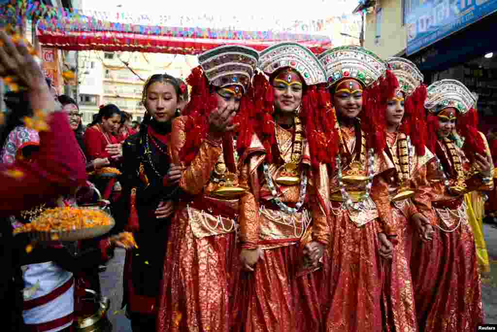 Participants from the Newar community, dressed in traditional attire, take part in the parade to mark Jyapu Day and Yamari Puni festival in Kathmandu, Nepal.