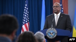 FILE - U.S. Defense Secretary Lloyd Austin speaks during a press conference at the Pentagon, near Washington, on Nov. 16, 2022. At a recent security forum in Canada, Austin warned that Beijing and Moscow seek a world "where disputes are resolved by force."