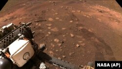 FILE - This March 4, 2021, NASA photo features the Perseverance rover on Mars. The rover happened to have its microphone on when a tower of red dust whirled overhead on Sept. 27, 2021, resulting in first-of-its-kind audio that scientists shared with the world on Dec. 13, 2022.