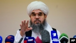FILE - Taliban official Shahabuddin Dilawar gestures during a news conference in Moscow, Russia, July 9, 2021. Now the group's mining minister, Daliwar has hailed an investment deal it closed with China on the extraction of oil in northern Afghanistan.
