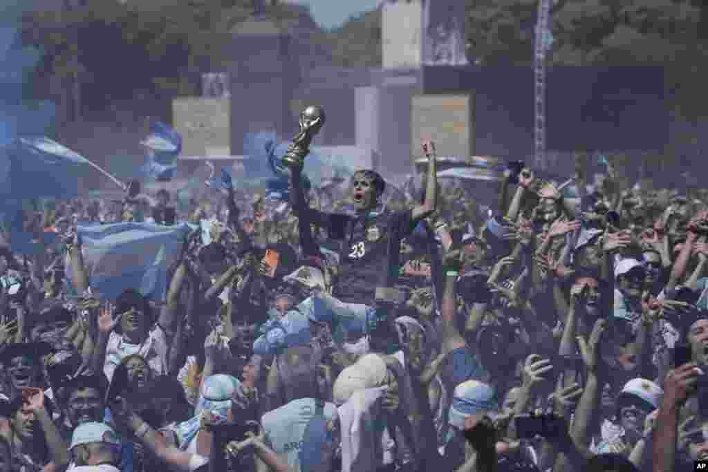Argentine fans in Buenos Aires celebrate during the World Cup final soccer match between Argentina and France in Qatar.