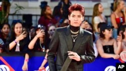 FILE - Singer Kris Wu celebrates his award for Fan Fave New Artist on the red carpet at the iHeartRadio MMVAs in Toronto on Aug. 26, 2018.