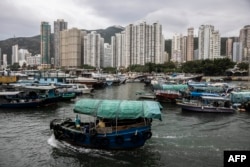 FILE - A Sampan boat, center, takes passengers in Ap Lei Chau in Hong Kong, Nov. 21, 2022. Tourism in Hong Kong has remained low in comparison to before the COVID-19 pandemic.