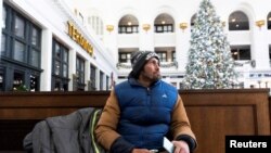 Beau Rickwire sits at Union Station to warm up during a period of cold weather in the city of Denver, Colorado, in the United States, Dec. 22, 2022. Rickwire has been homeless for five years.