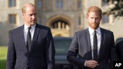 FILE - Britain's Prince William, Prince of Wales, left and Prince Harry walk to meet members of the public at Windsor Castle, in Windsor, England, Sept. 10, 2022. In his new book "Spare," Harry talks about his struggles as well as his life as a royal and "spare" to the throne.