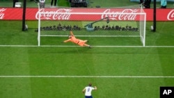 England's Harry Kane misses a penalty shot sending the ball over the bar as France's goalkeeper Hugo Lloris dives during the World Cup quarterfinal soccer match between England and France, at the Al Bayt Stadium in Al Khor, Qatar, Saturday, Dec. 10, 2022.