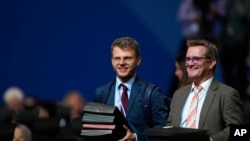 Documents are brought in for a closing plenary session at the COP27 UN Climate Summit, Nov. 20, 2022, in Sharm el-Sheikh, Egypt.